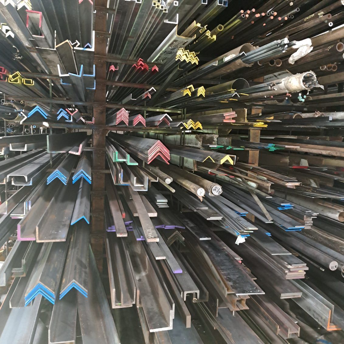 A warehouse filled with lots of different types of metal pipes.