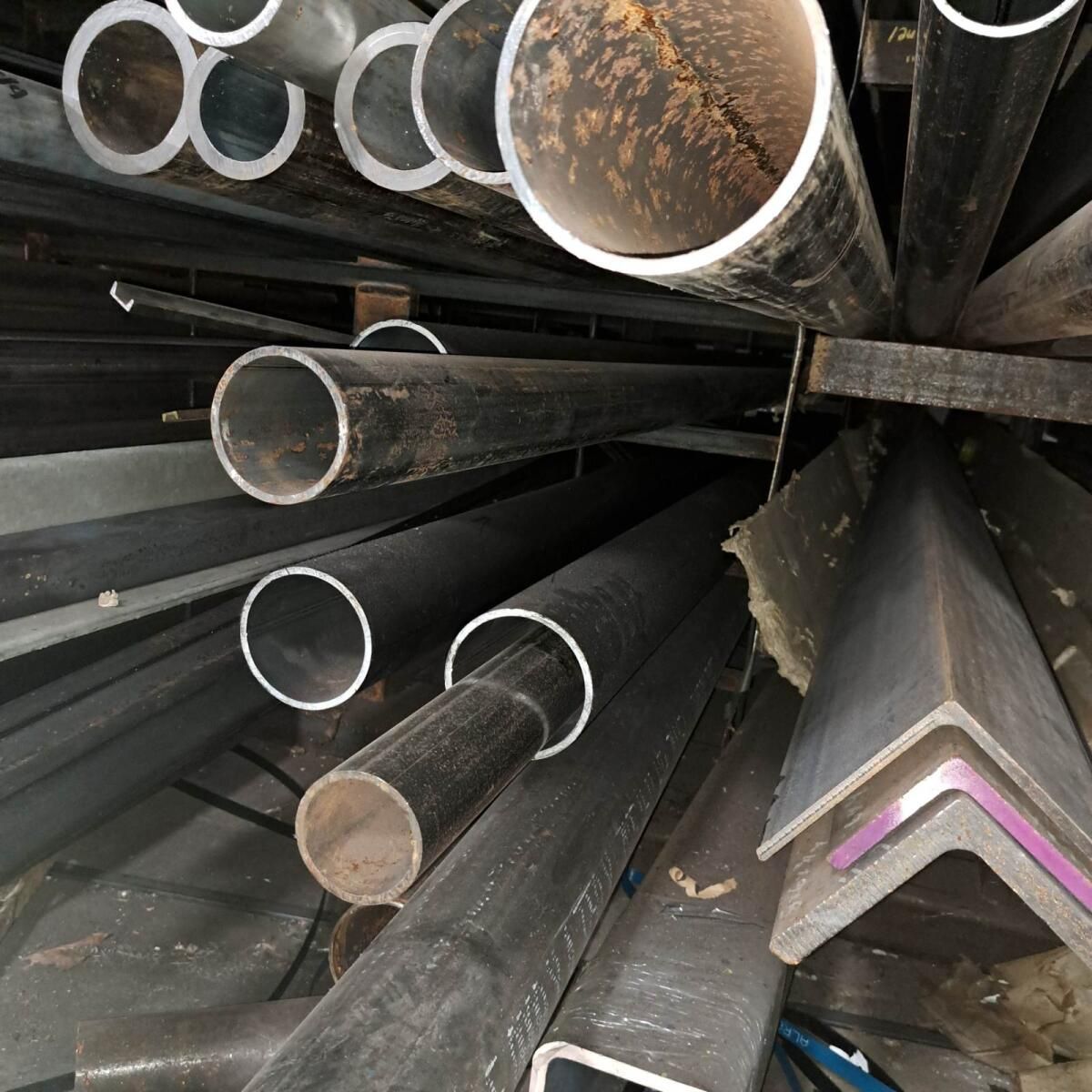 A bunch of metal pipes are stacked on top of each other