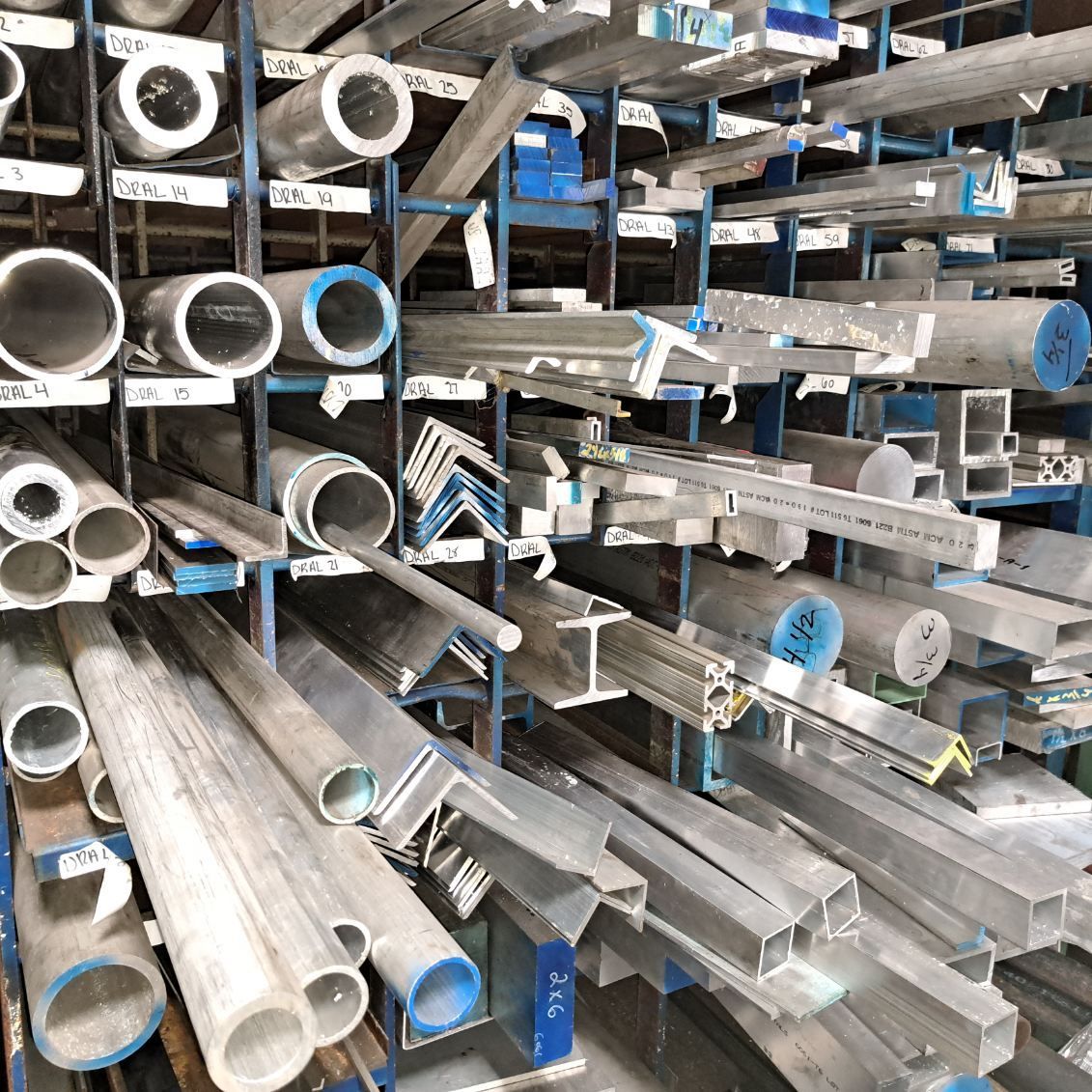 A warehouse filled with lots of aluminum pipes and tubes.