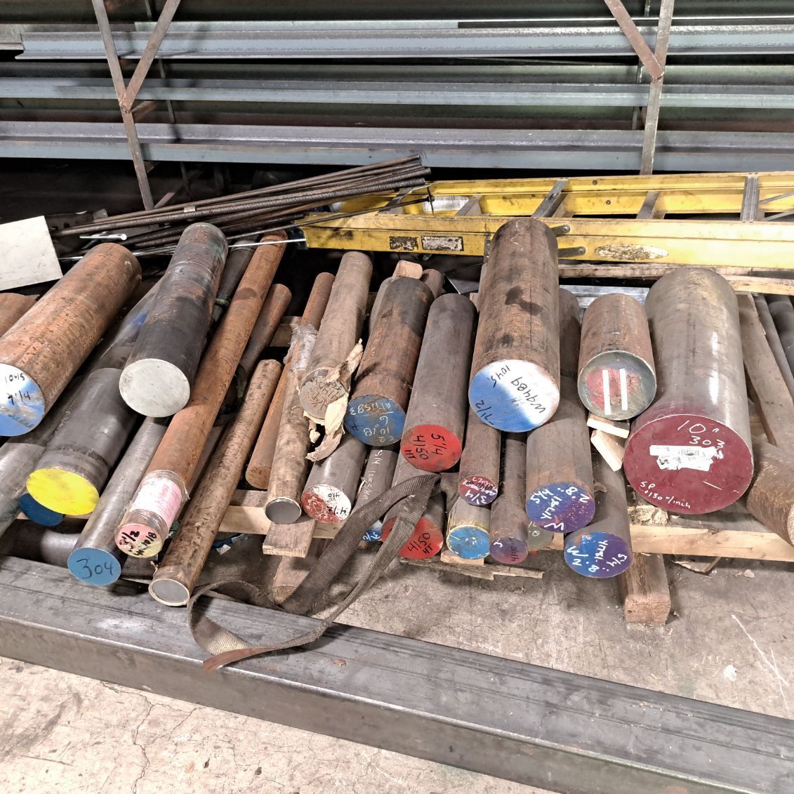 A bunch of metal rods are stacked on top of each other on a table.