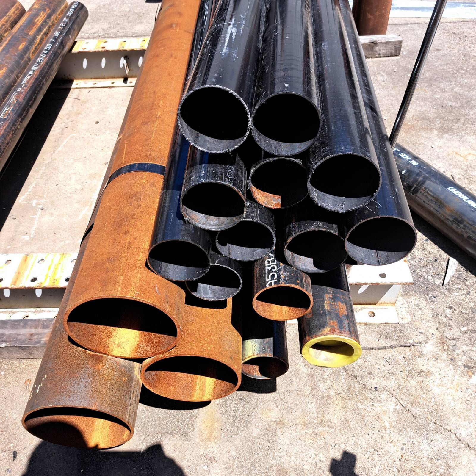 A bunch of metal pipes are stacked on top of each other