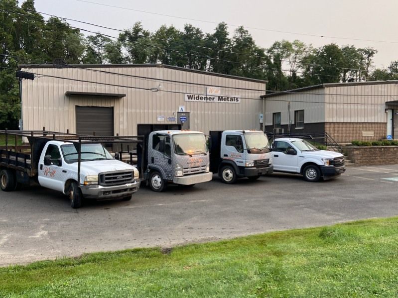 A row of trucks parked in front of a building.