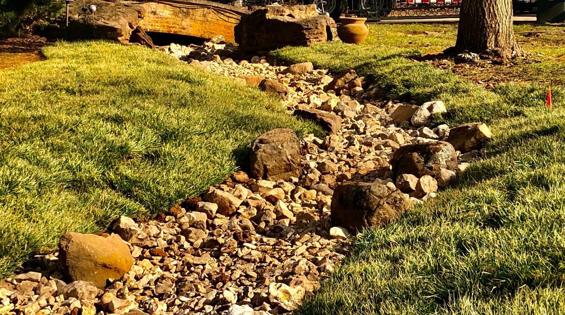 Rock garden path bordered by grass and stones in a sunny park