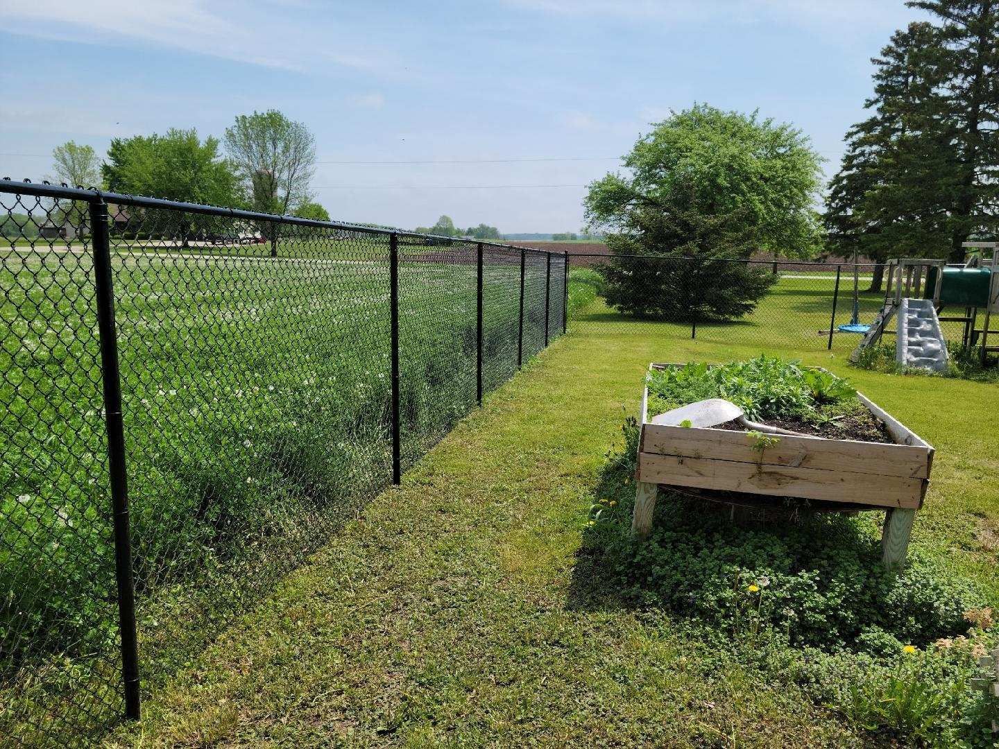 A house with a black fence in front of it.