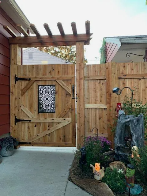 A wooden fence surrounds a house with a sign that says ' fence ' on it