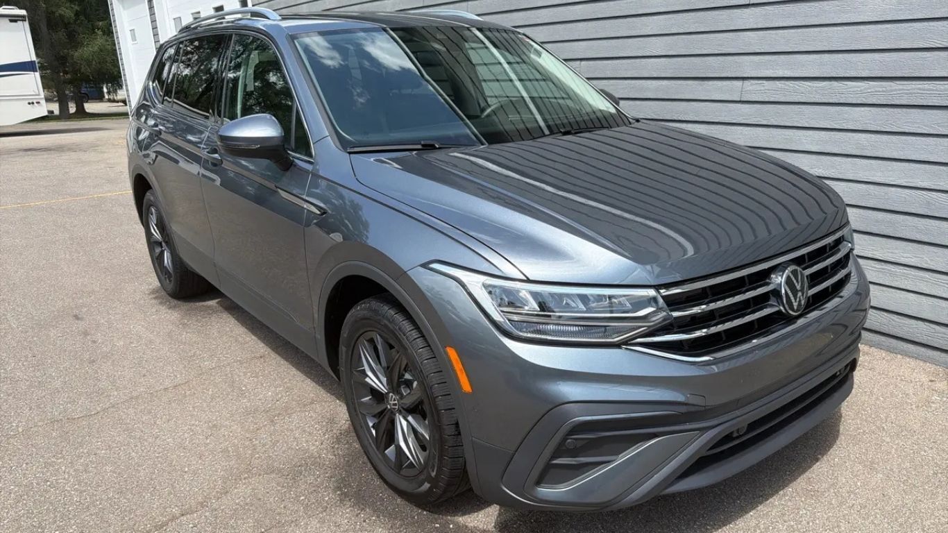 Gray Volkswagen SUV parked beside a building, front-left view.