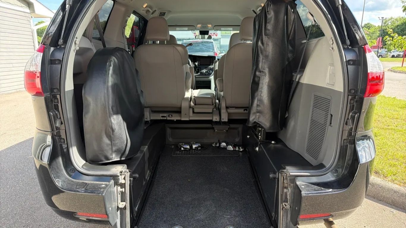 Open SUV cargo area with rear seats folded down, showing a black cargo floor and tan interior.