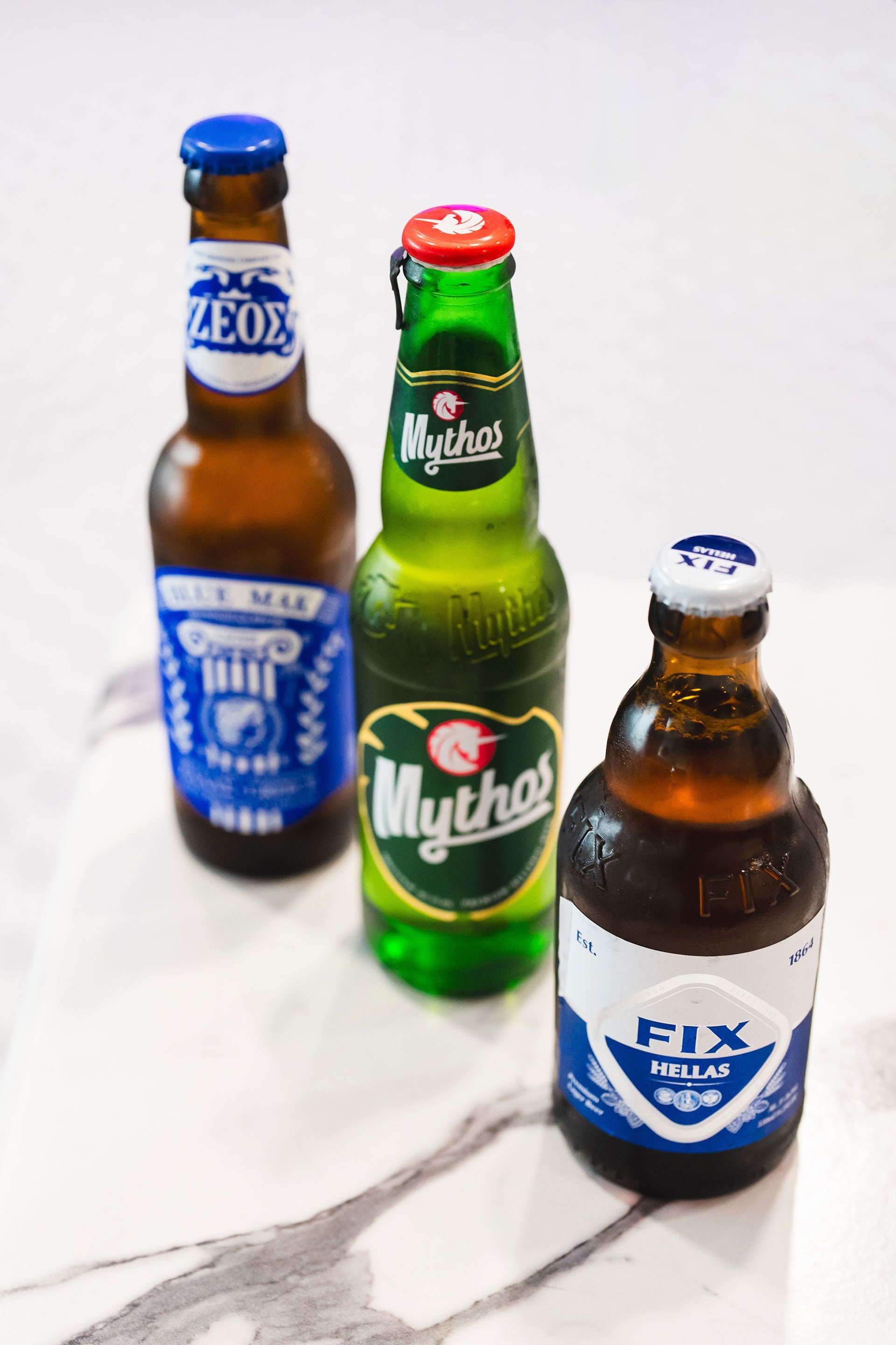 Three bottles of beer are sitting next to each other on a table