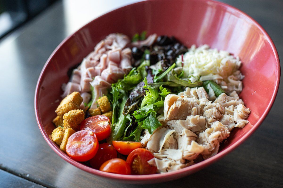 A close up of a bowl of food on a table.