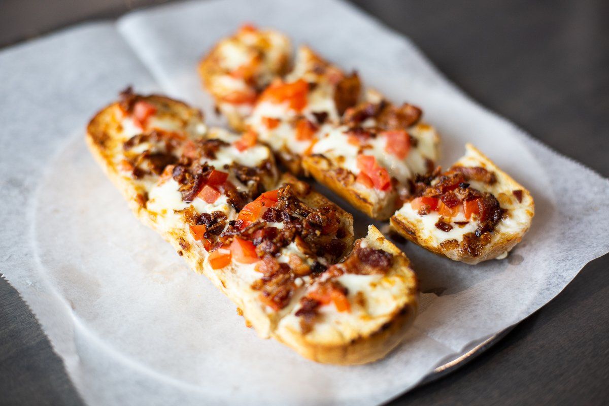 A close up of a pizza on a plate on a table.