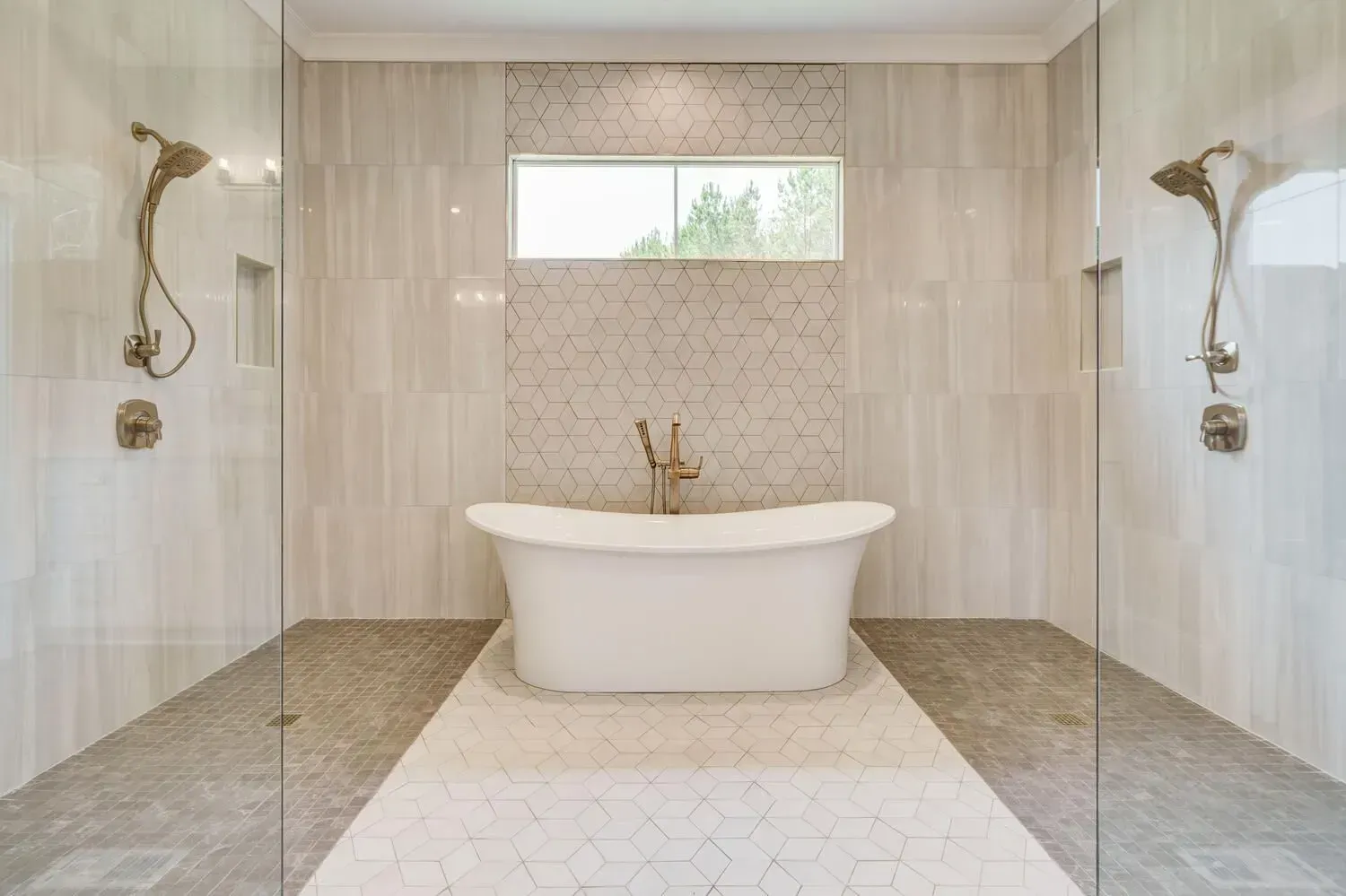 A modern wet-room bathroom with a central white freestanding tub, flanked by dual glass-enclosed showers on beige tile.