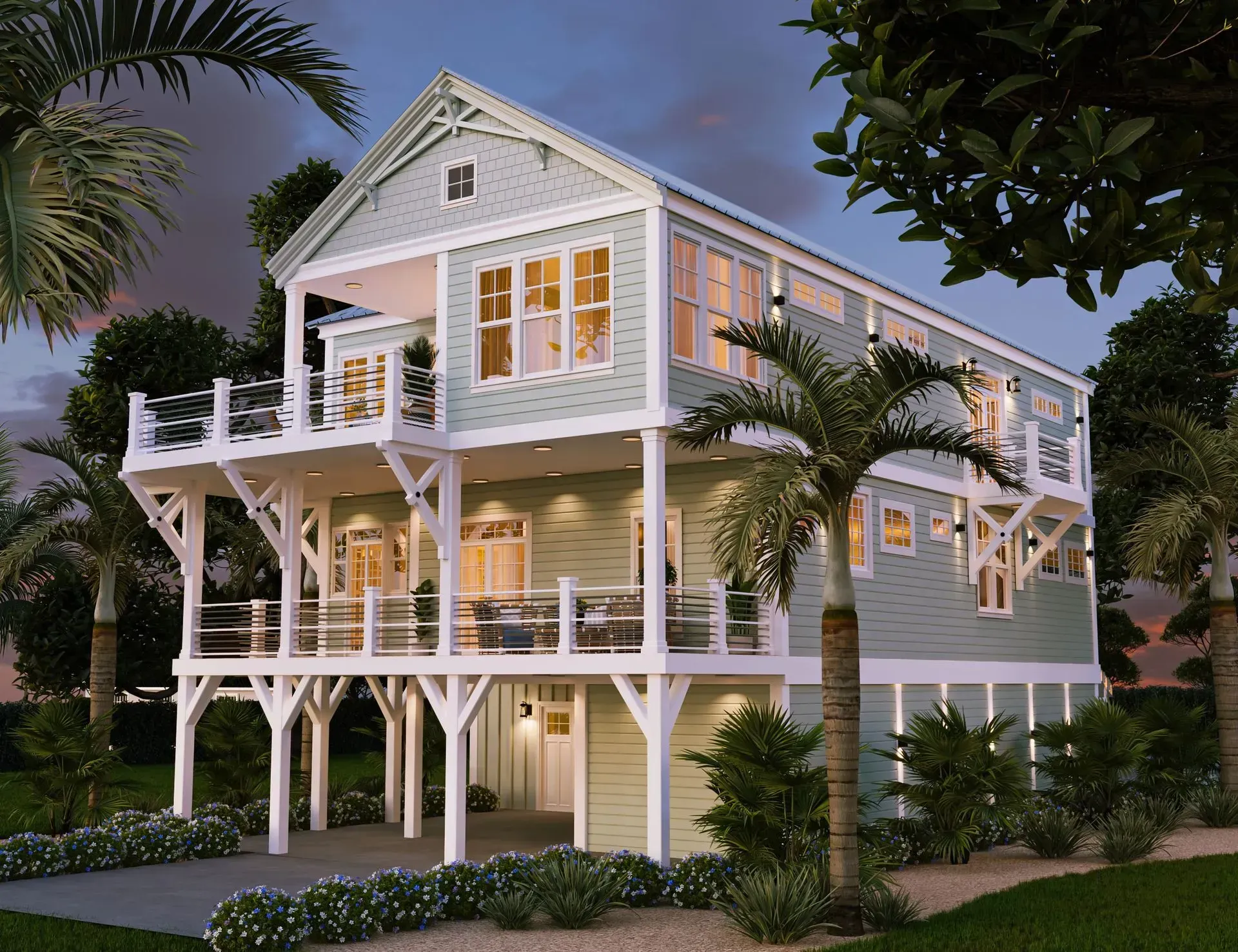 A light green two-story beach house on stilts at dusk, featuring wrap-around decks, white trim, and palm trees nearby.