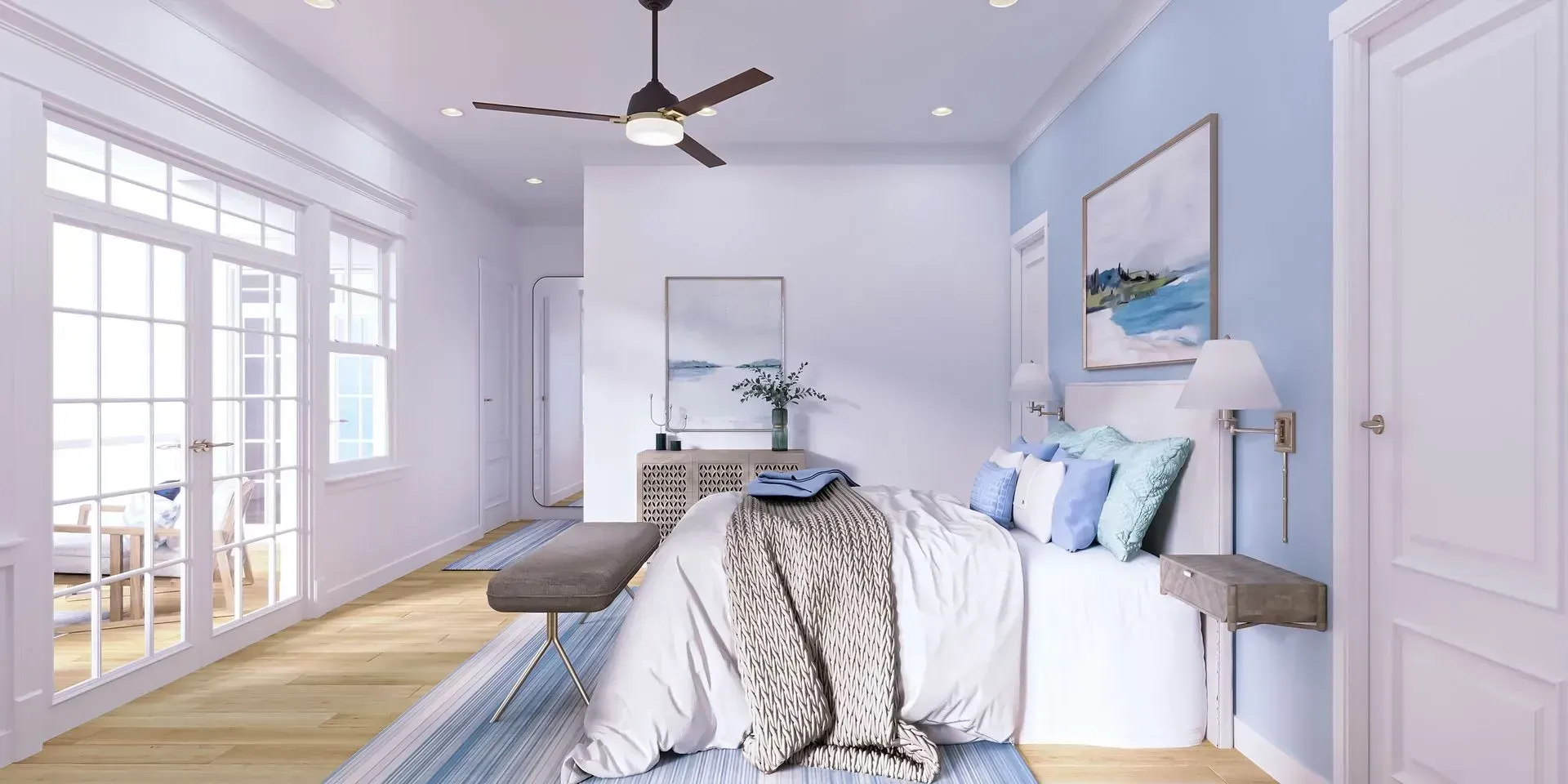 A bright bedroom with a queen bed, blue accent wall, ceiling fan, and sliding glass doors leading to a patio.