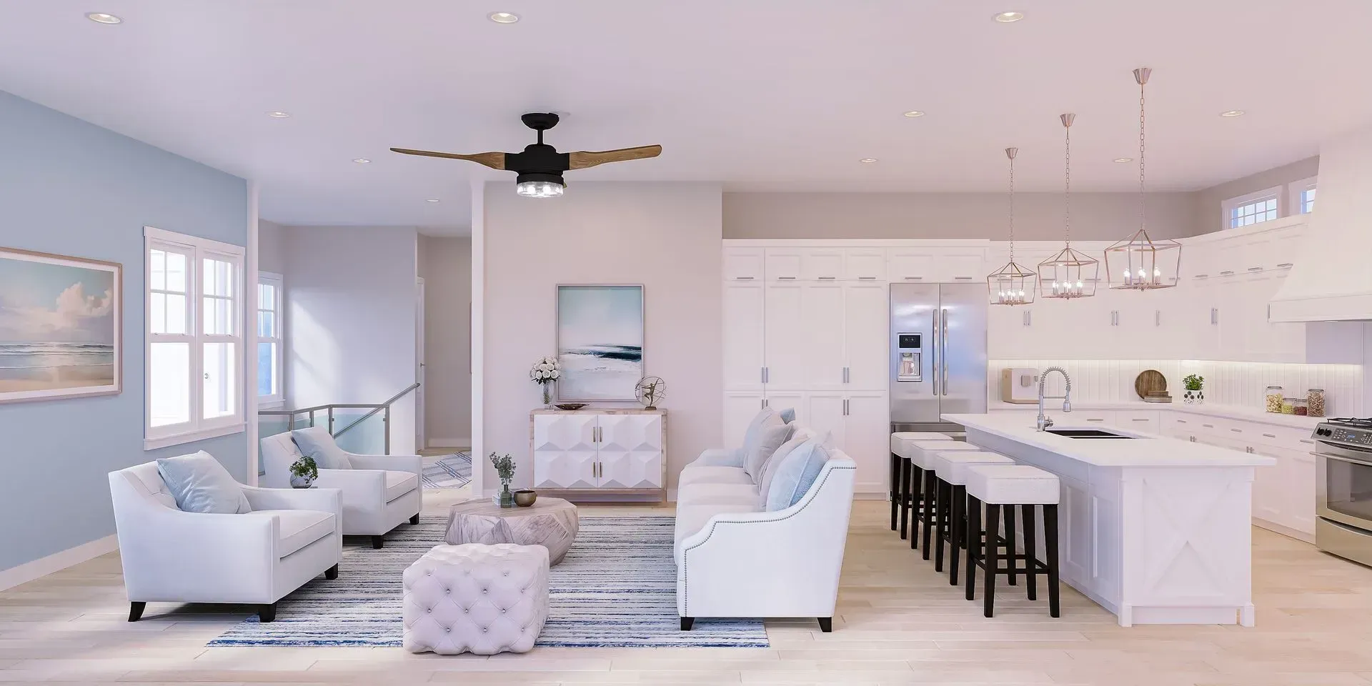 A bright, open-concept living room and kitchen featuring white furniture, a blue accent wall, and a large kitchen island.