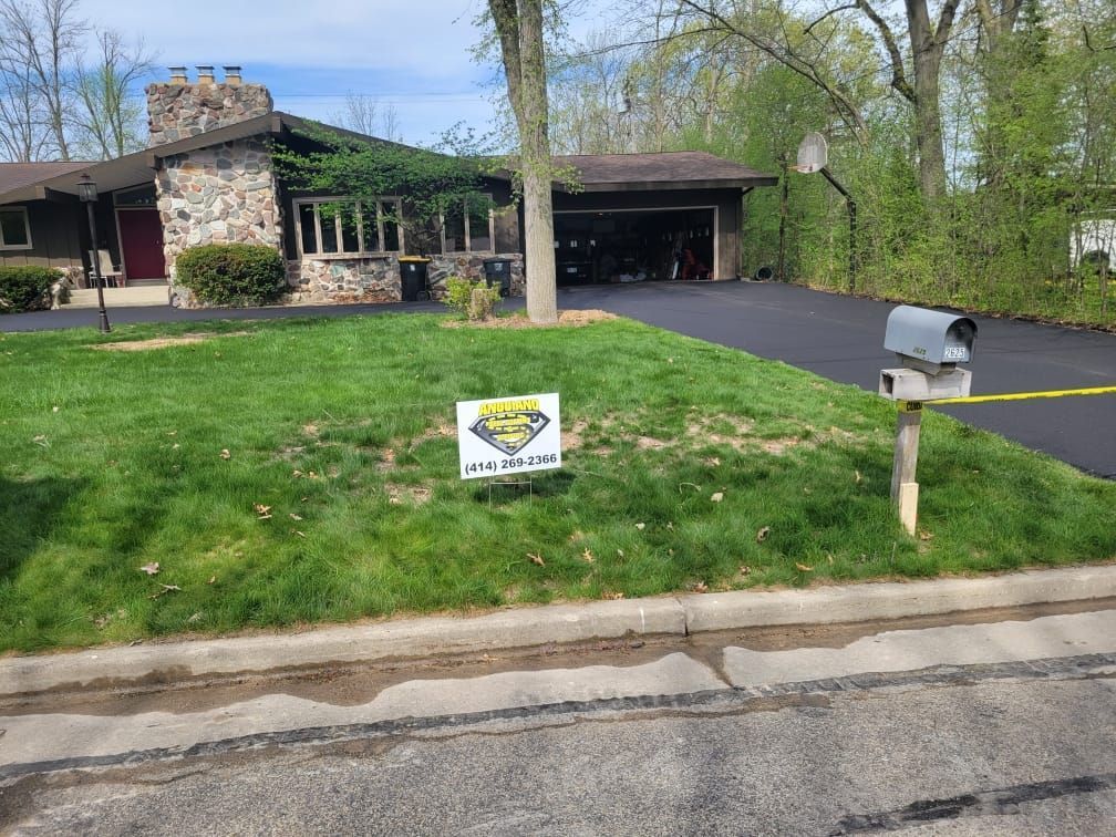 A house with a mailbox and a sign in front of it.