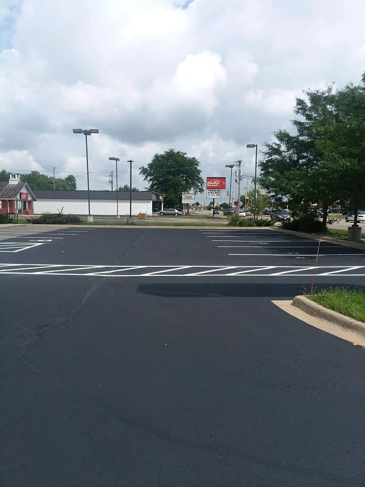 A parking lot with a building in the background