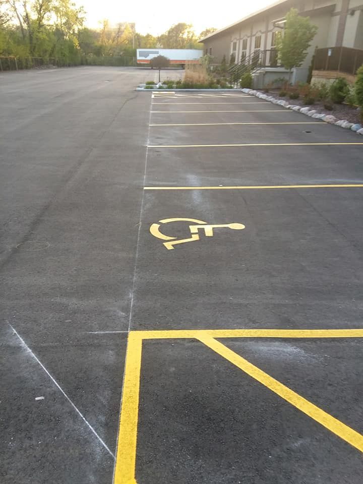 A parking lot with a handicap sign painted on the ground
