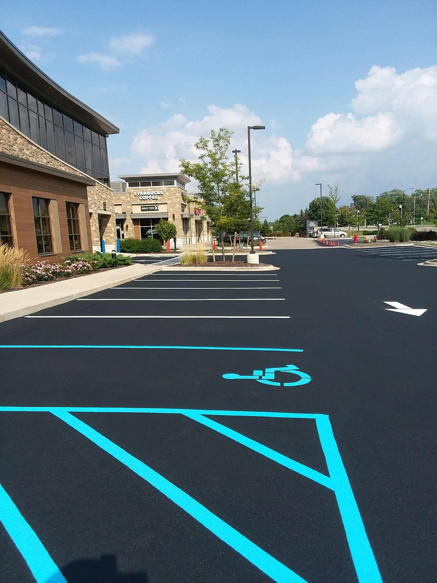 A parking lot with blue lines and a handicapped parking spot