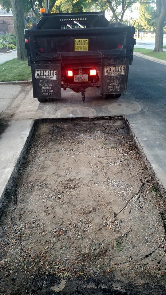 A dump truck ready to pour asphalt.