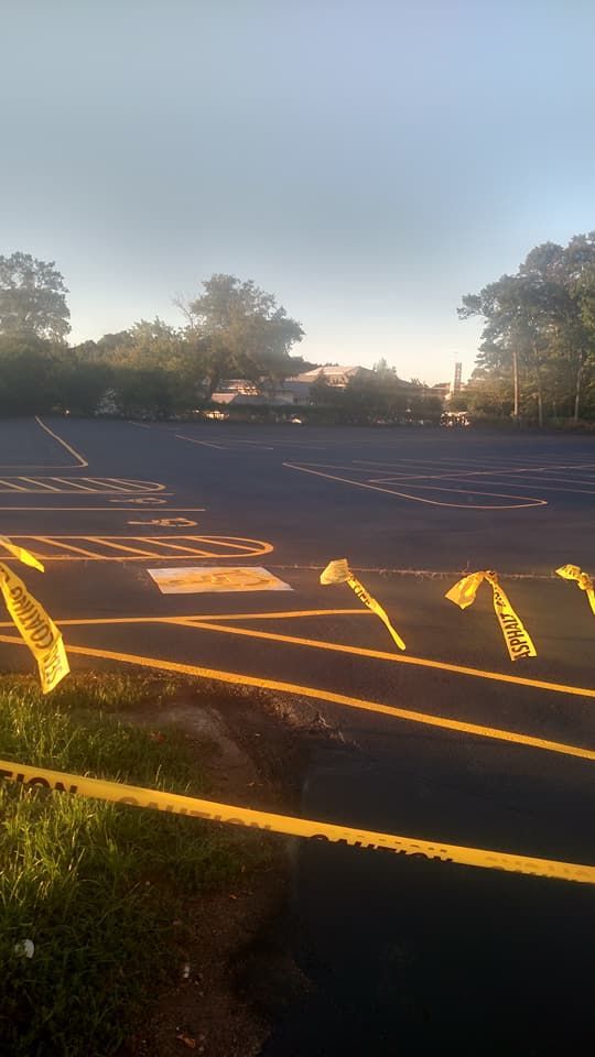 A parking lot with a lot of yellow tape around it.