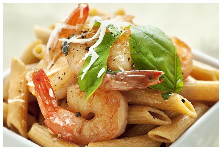 Penne pasta dish with cooked shrimp, garnished with basil and creamy sauce.