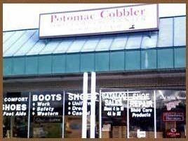 Storefront with a sign for Potomac Cobbler, blue awning, and shoe repair and boot sale window signs