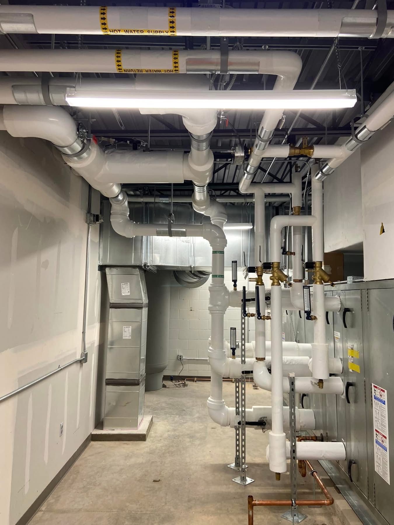 A room with a lot of pipes going through it