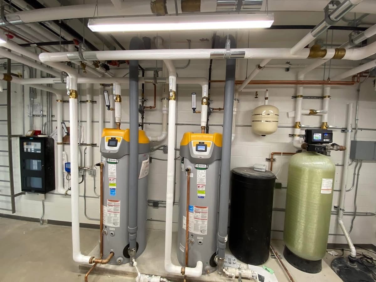 A row of water heaters are lined up in a room