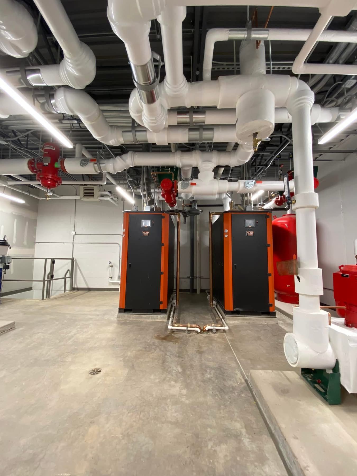 A room with a lot of pipes coming out of the ceiling.