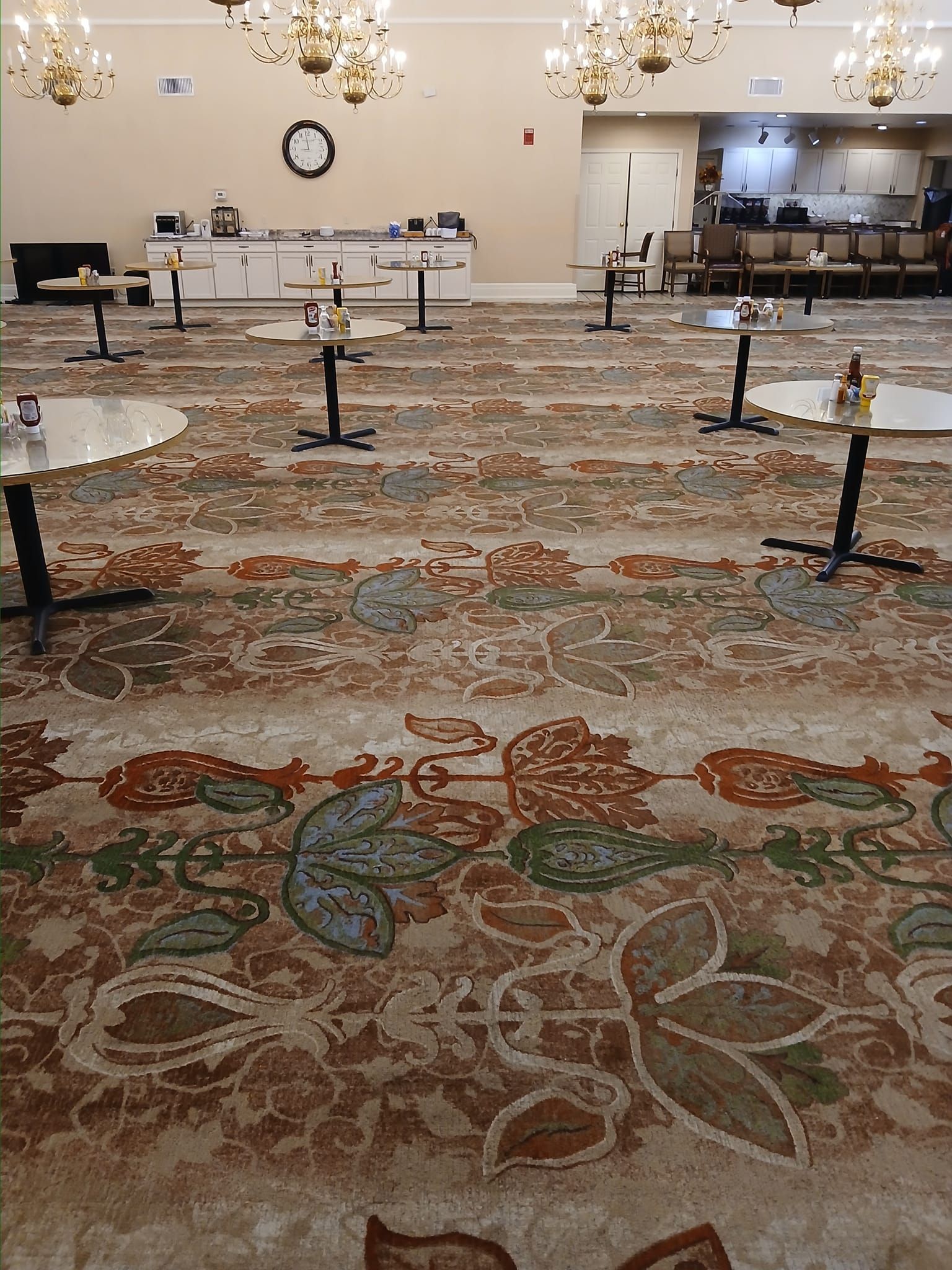 A large room with tables and chairs in it.