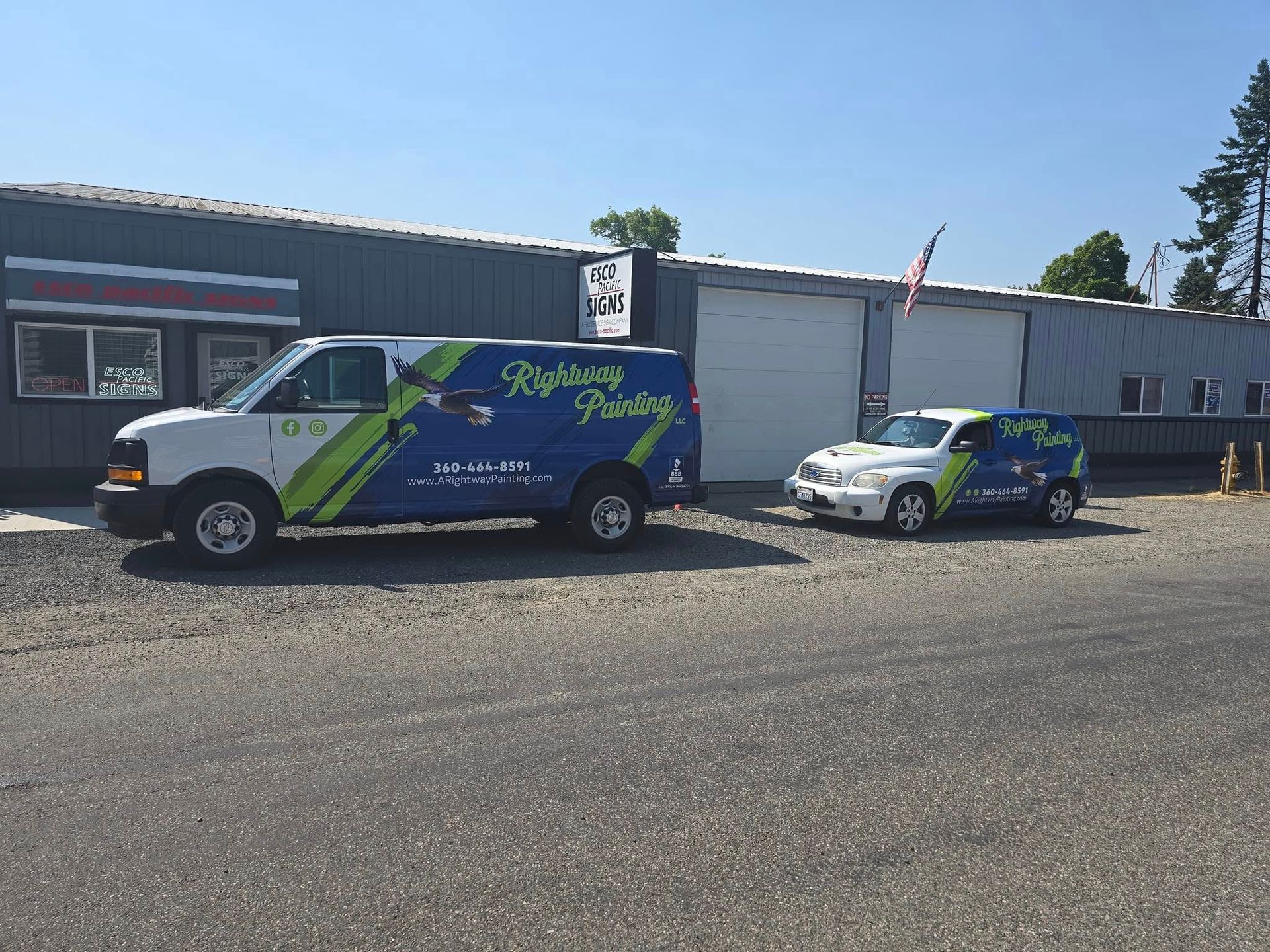 Two vehicles with business logos parked outside a building.