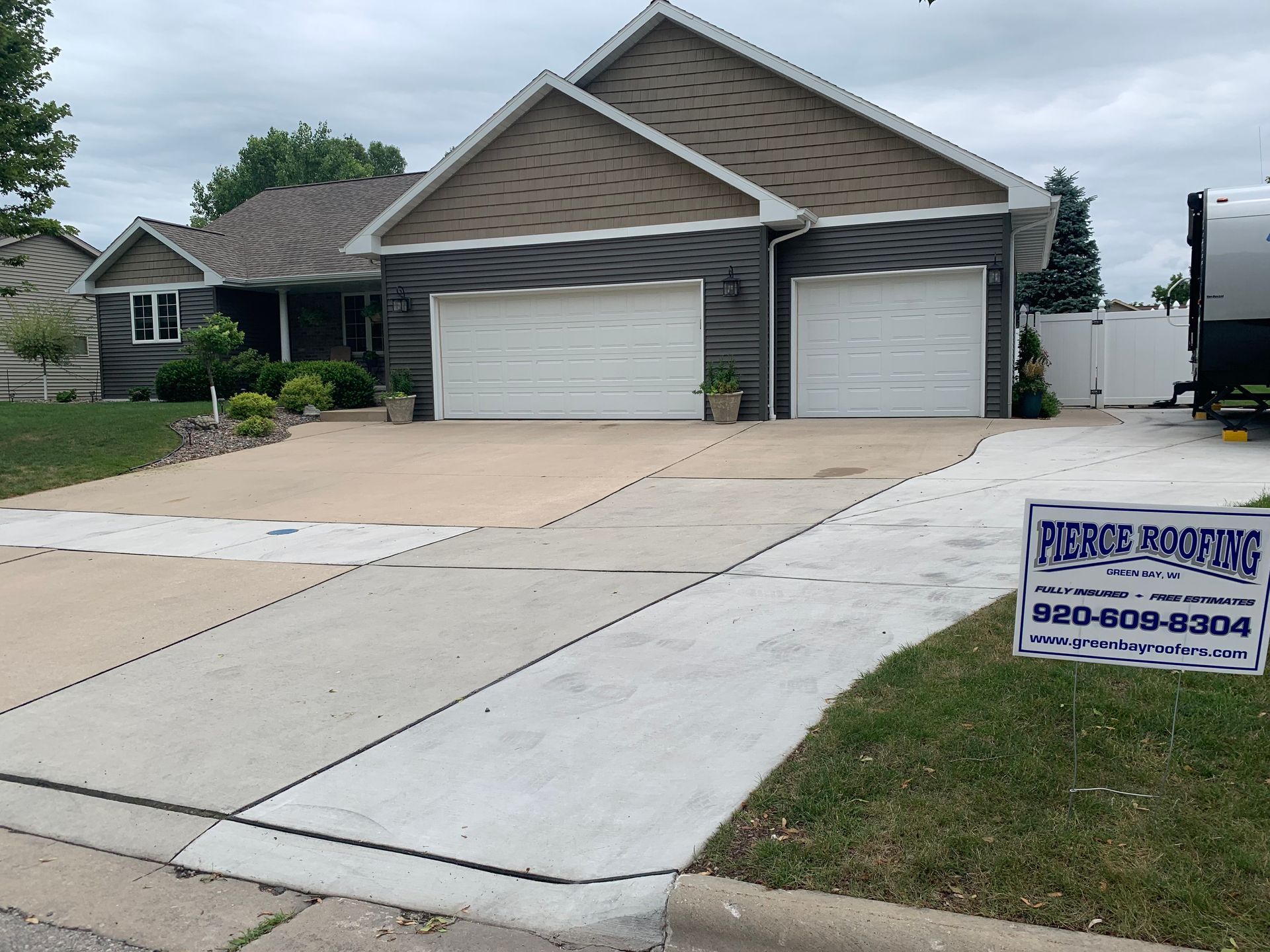 A house with a sign in front of it that says pierre roofing
