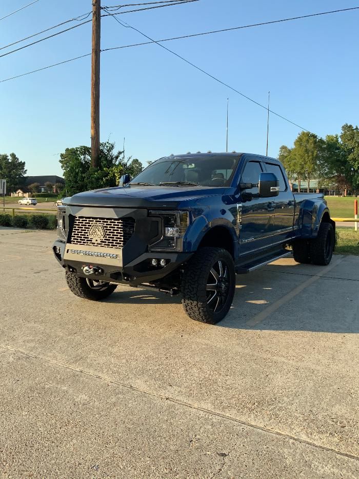 A black pickup truck is parked in a parking lot.