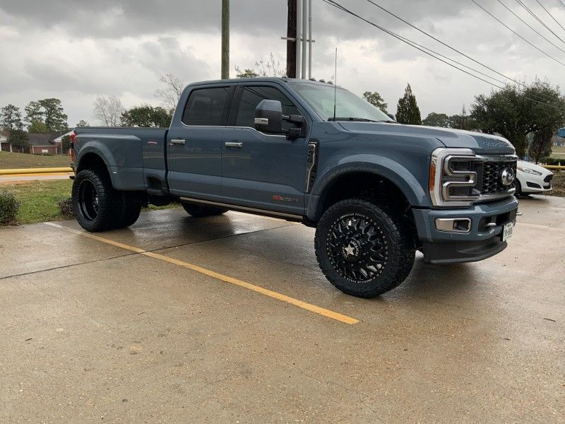 A ford truck is parked in a parking lot on a cloudy day.