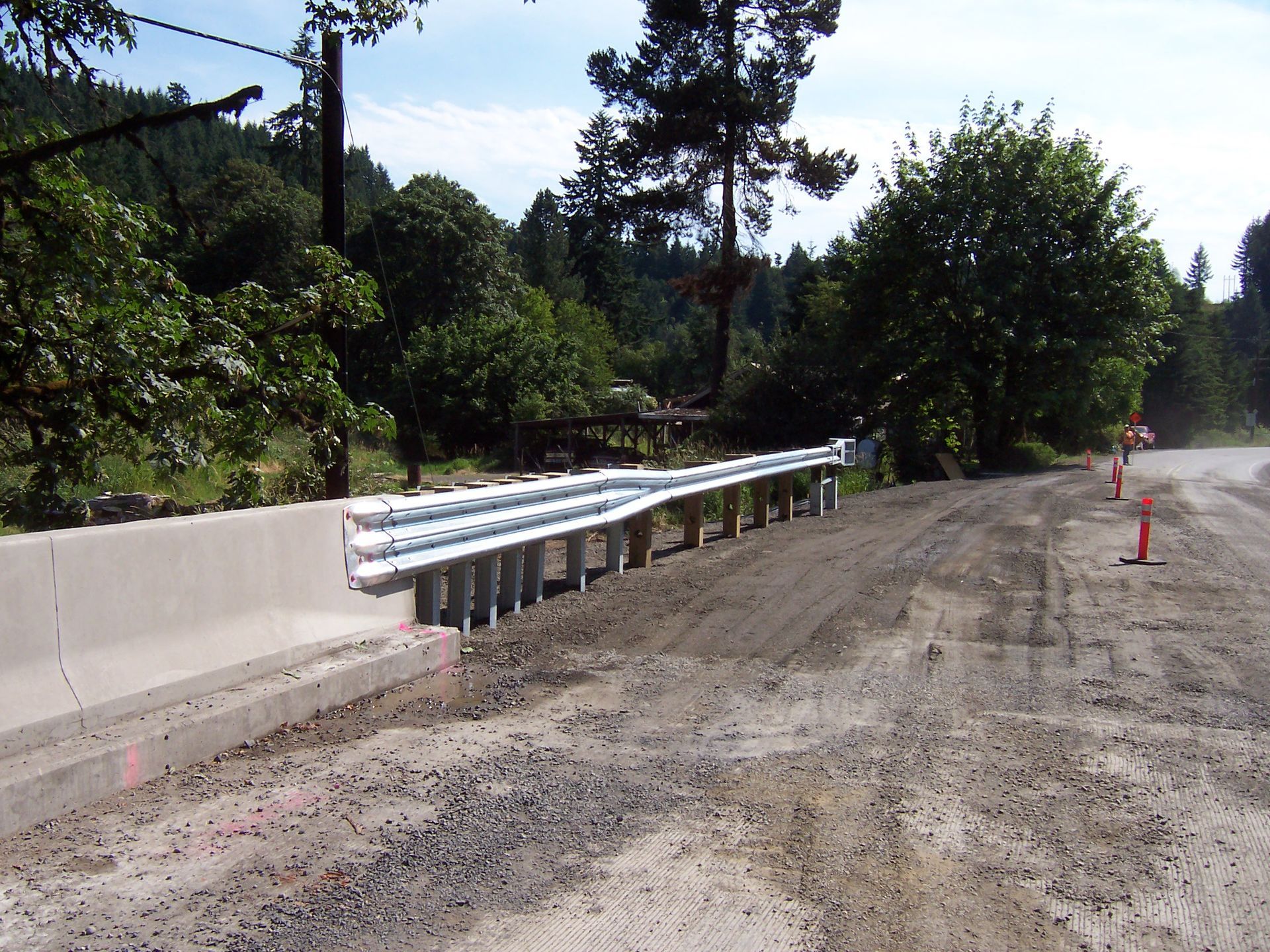 A road with a concrete barrier on the side of it