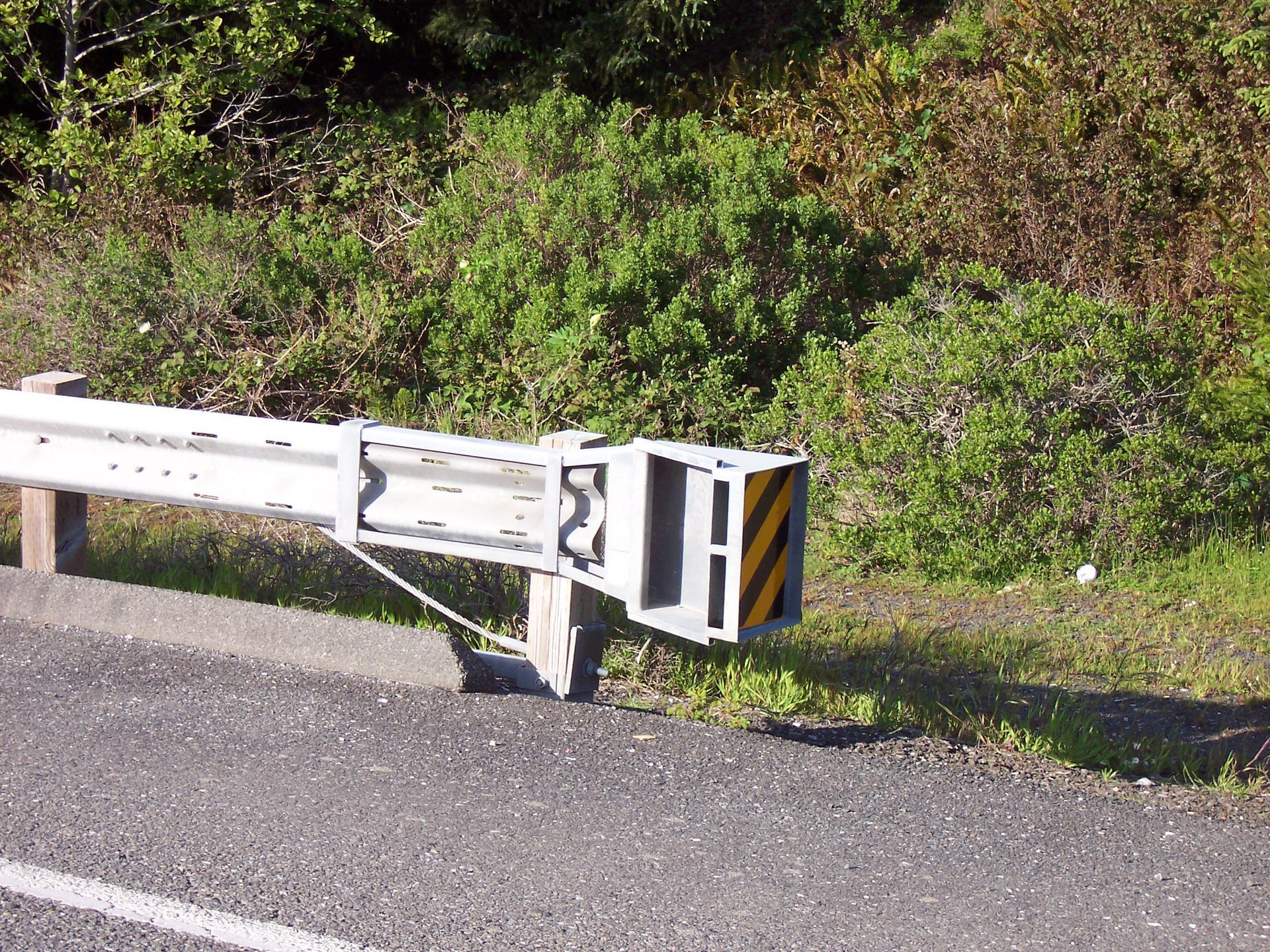 A metal railing on the side of a road with the letter e on it