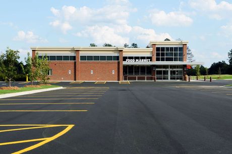 An empty parking lot in front of a food market