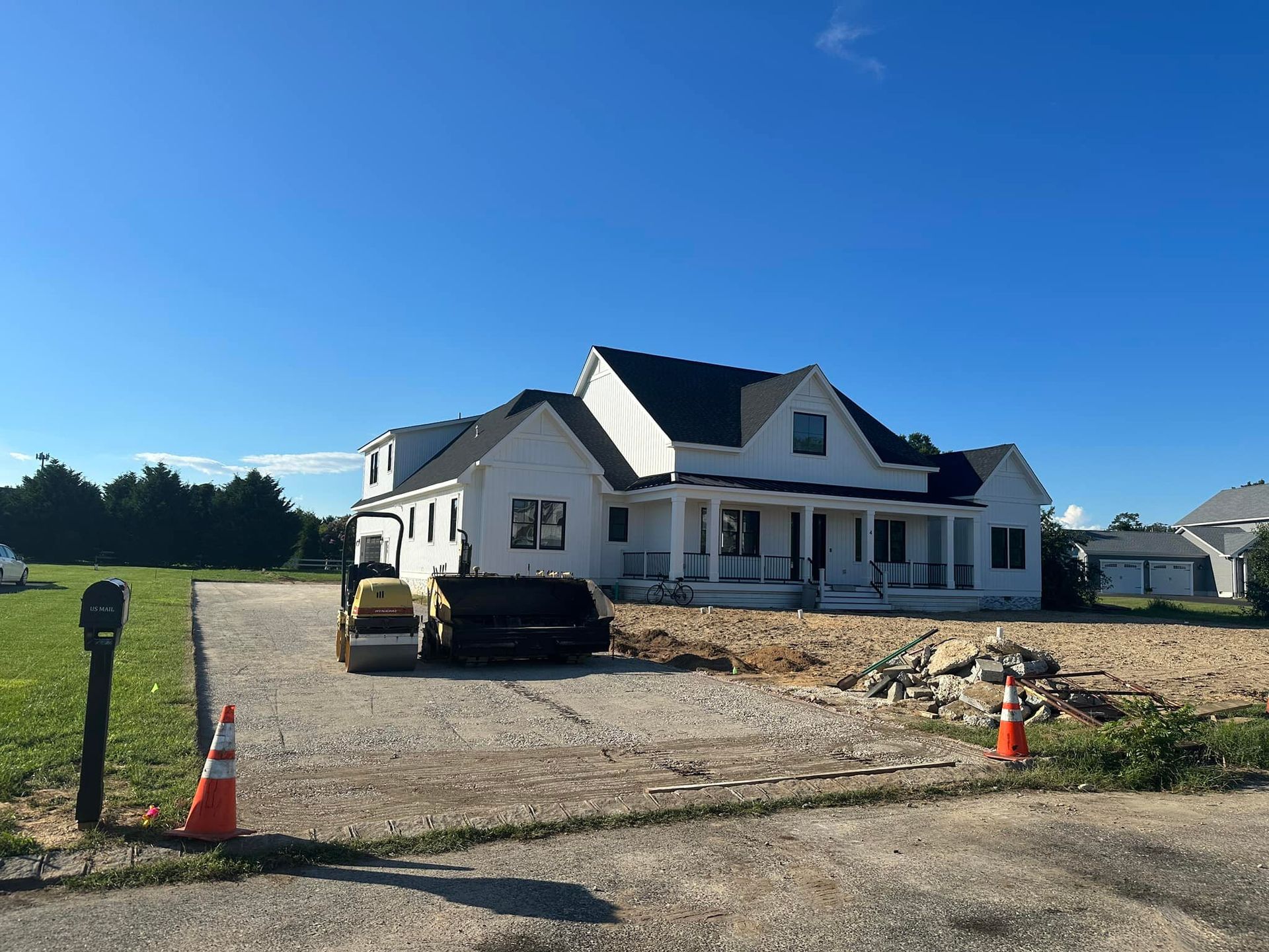 A large white house is being built in a rural area.