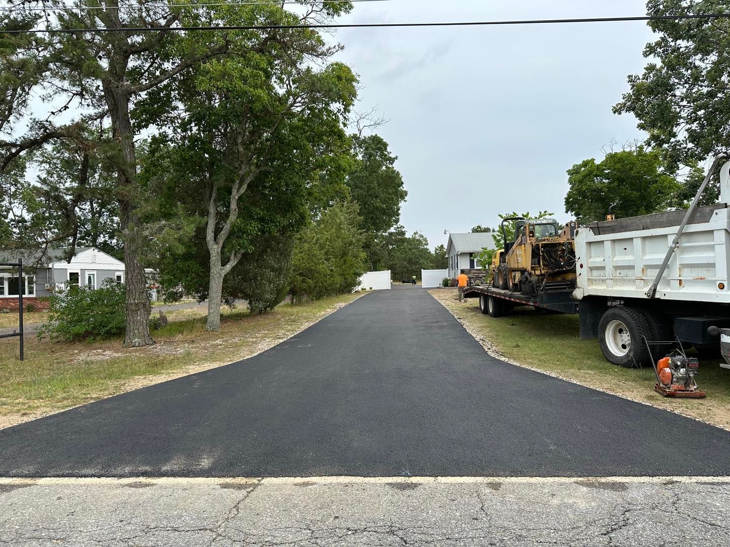A dump truck is parked on the side of a road.