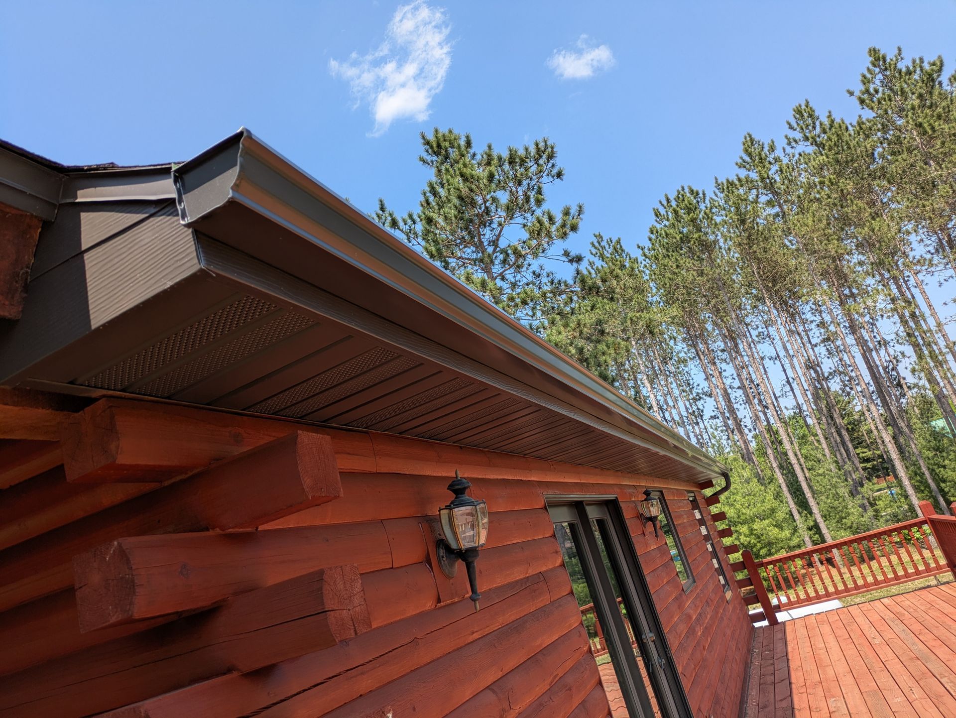 A log cabin with a gutter on the side of it.