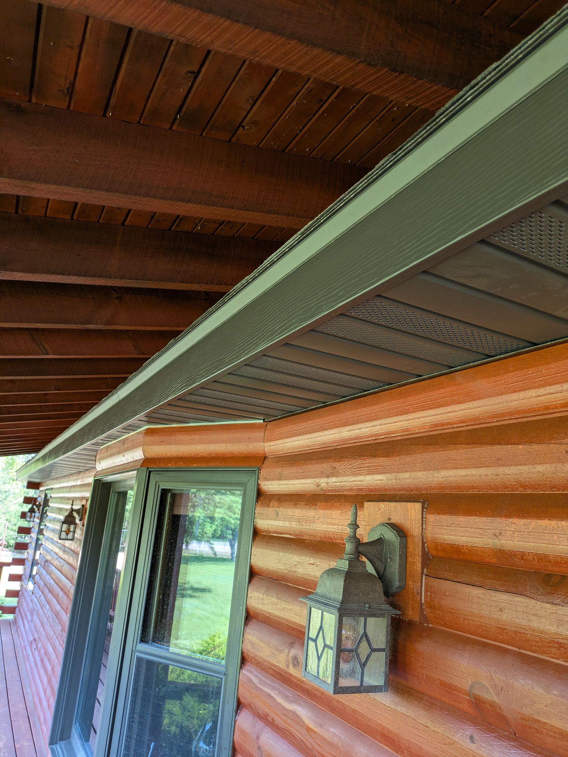 A log cabin with a lantern on the side of it