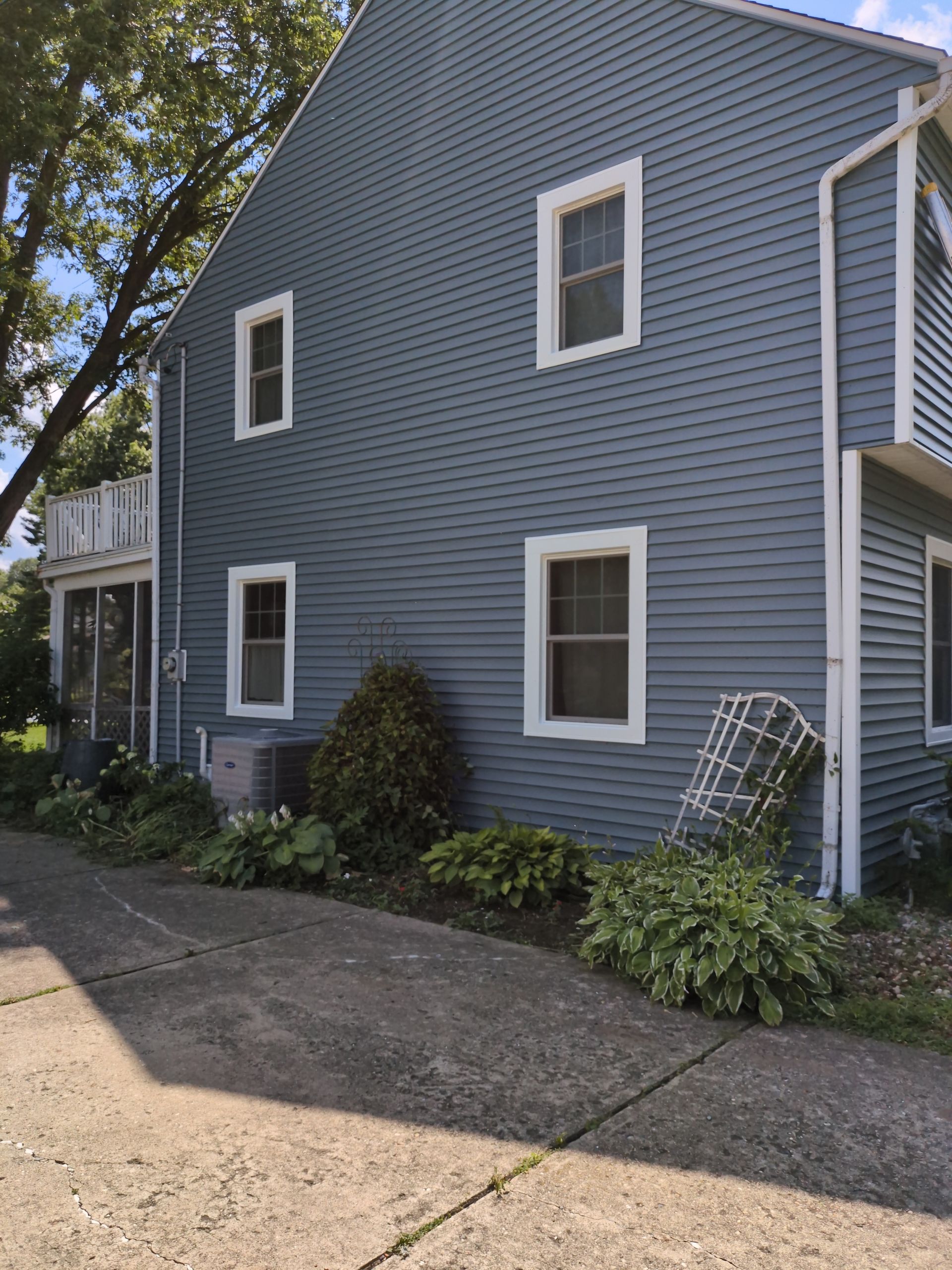 A blue house with white trim and a lot of windows