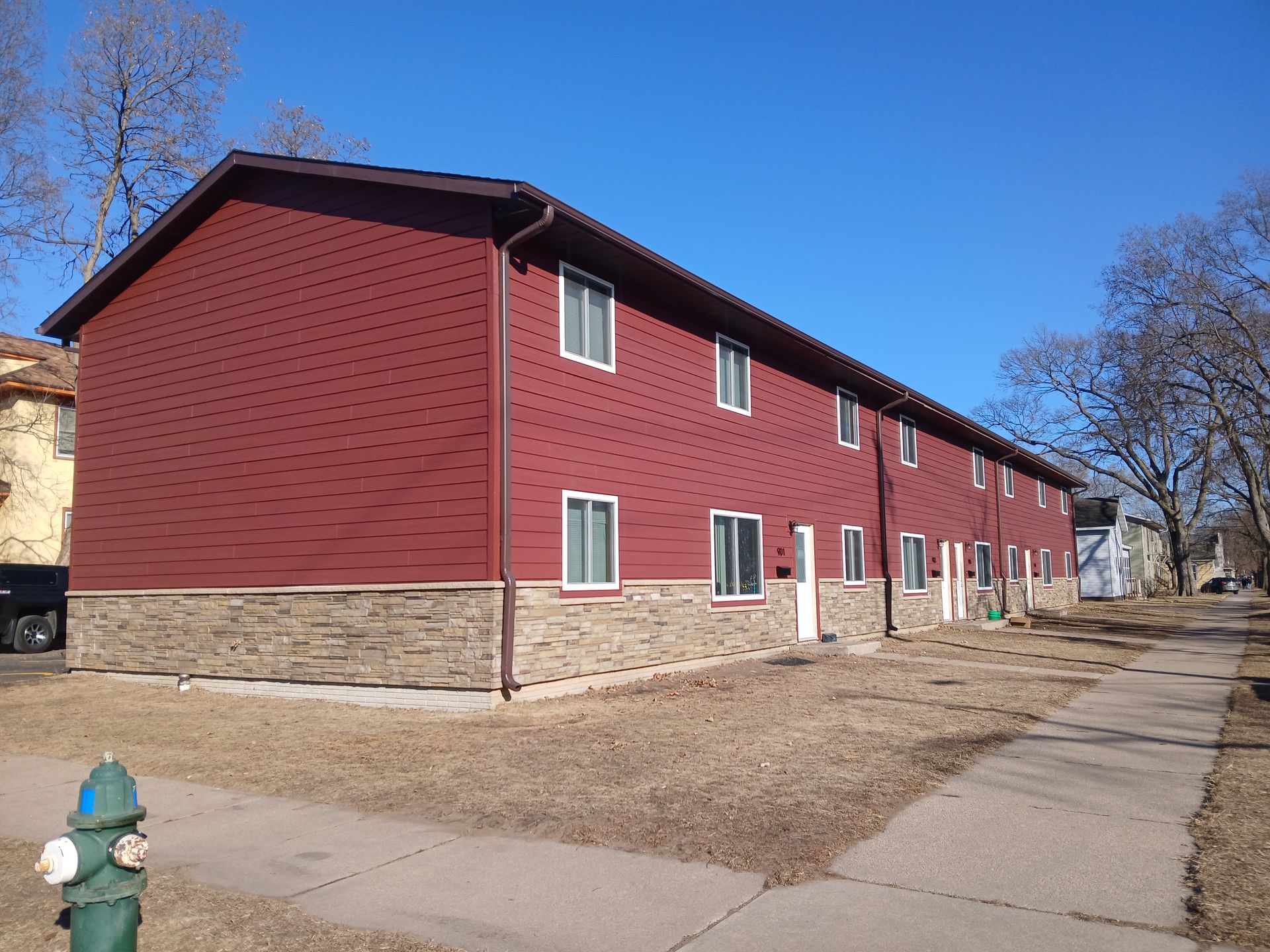 A red building with a fire hydrant in front of it