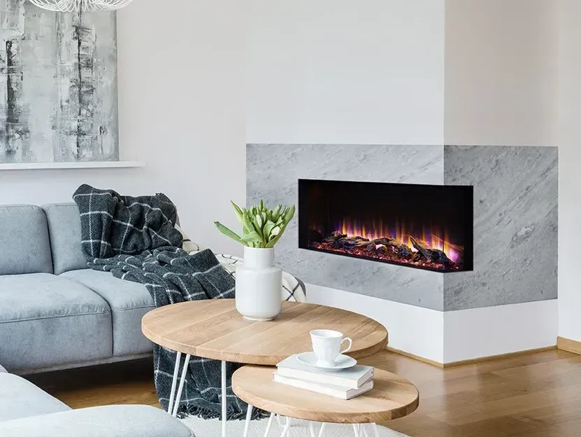 Modern living room with corner electric fireplace, grey sofa, and wooden coffee tables.