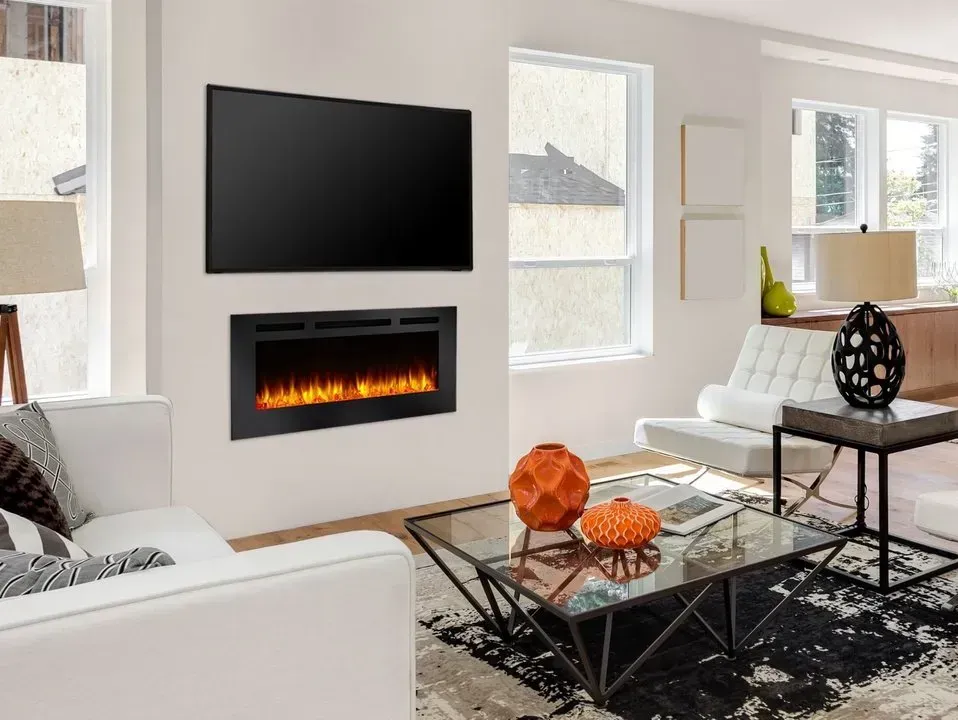 Living room with a mounted TV over a fireplace. White walls, furniture, and a coffee table.
