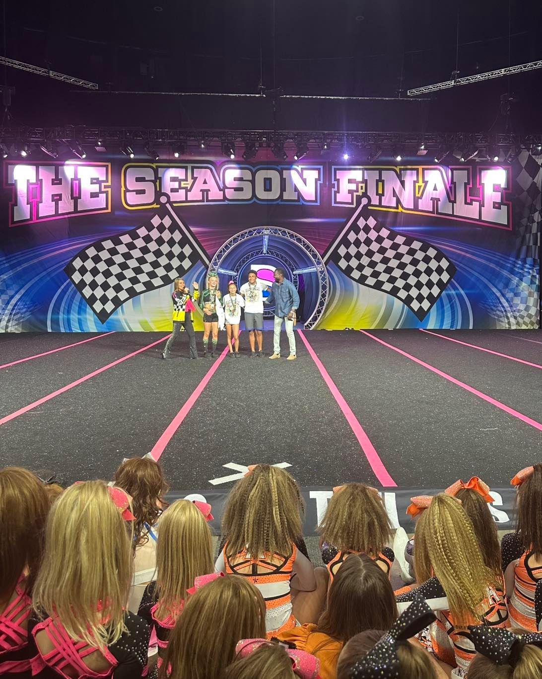 Contestants on a lit stage beneath “THE SEASON FINALE” banner, with audience watching in front.
