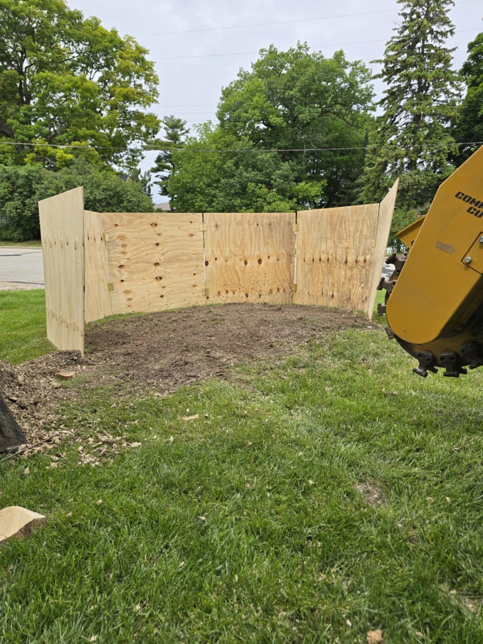 A wooden fence is being built around a tree stump.