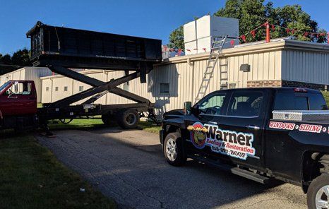Warner Roofing & Restoration vehicles