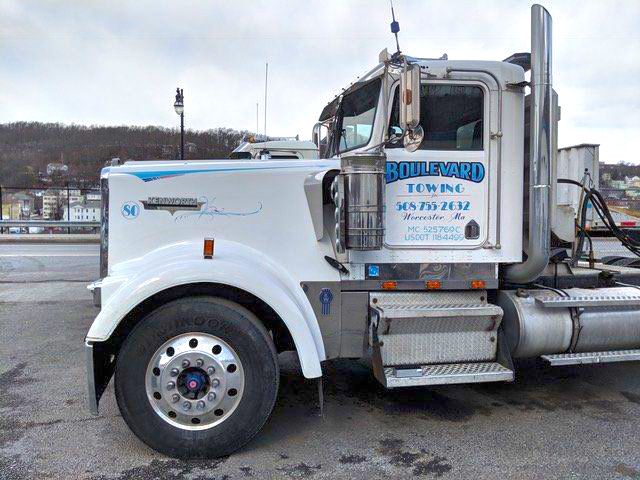 White tow truck with business name
