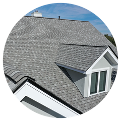 A house with a gray roof and a window on the roof.